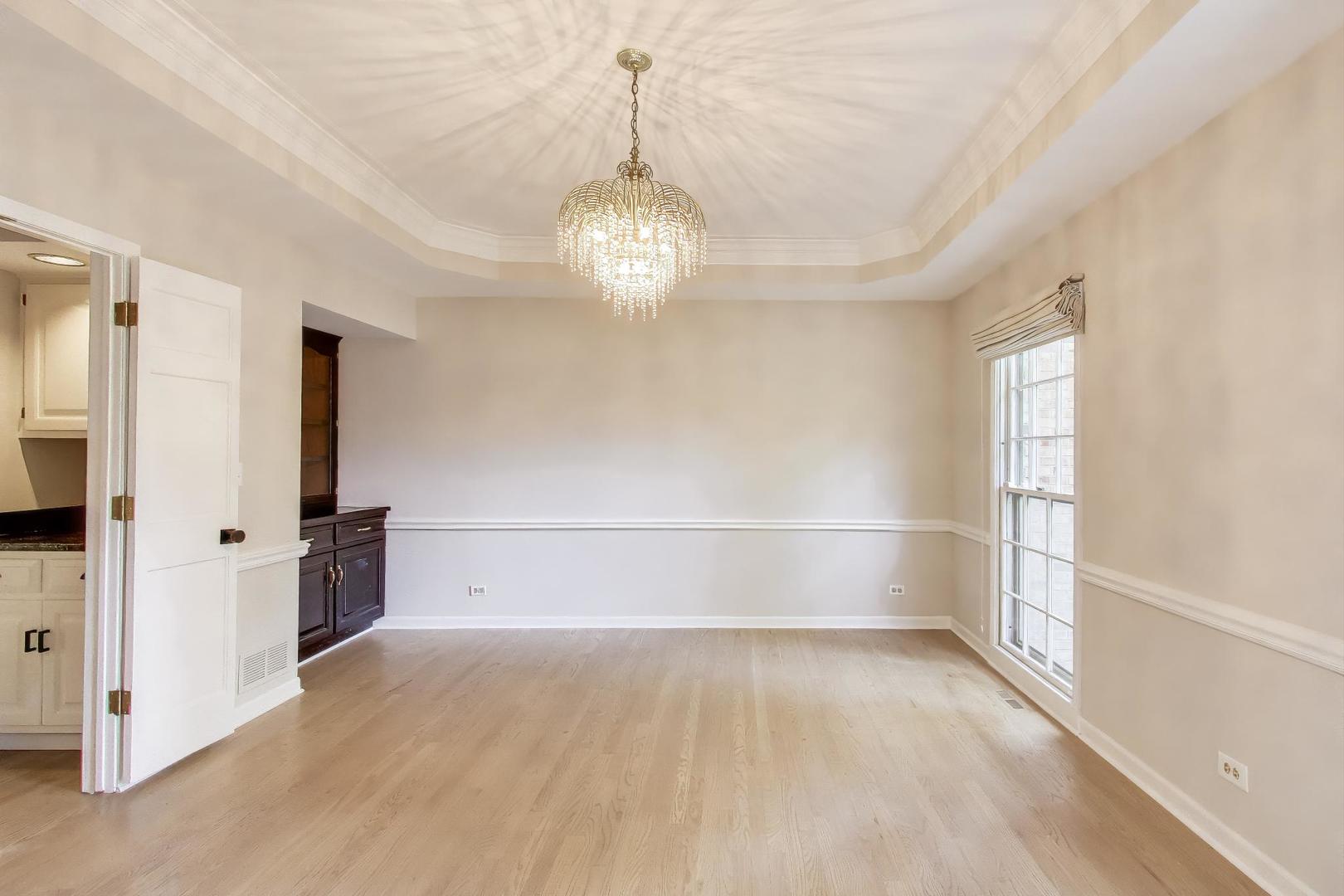 651 Nor-Oaks Court West Chicago, IL 60185 - Photo 13 of 62 wooden floor in an empty room with a window