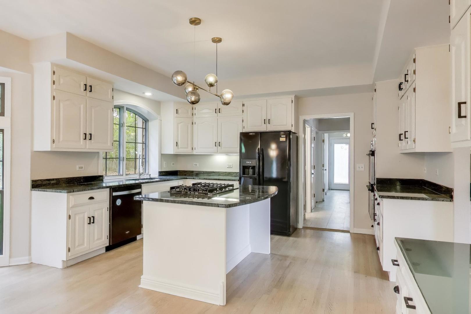651 Nor-Oaks Court West Chicago, IL 60185 - Photo 17 of 62 a kitchen with stainless steel appliances a stove a sink and a refrigerator