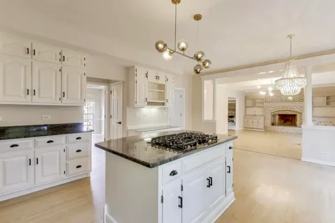 a view of an empty room with a fireplace and a large window