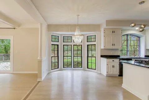 a view of an empty room with a fireplace and a window