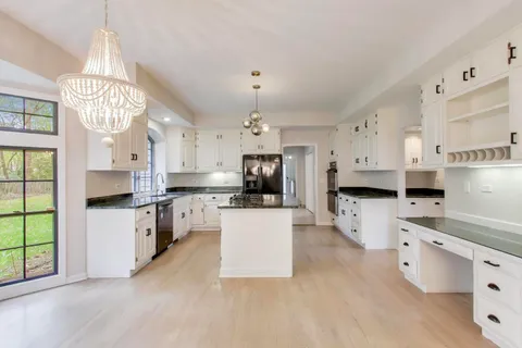 a view of a livingroom with a fireplace and window