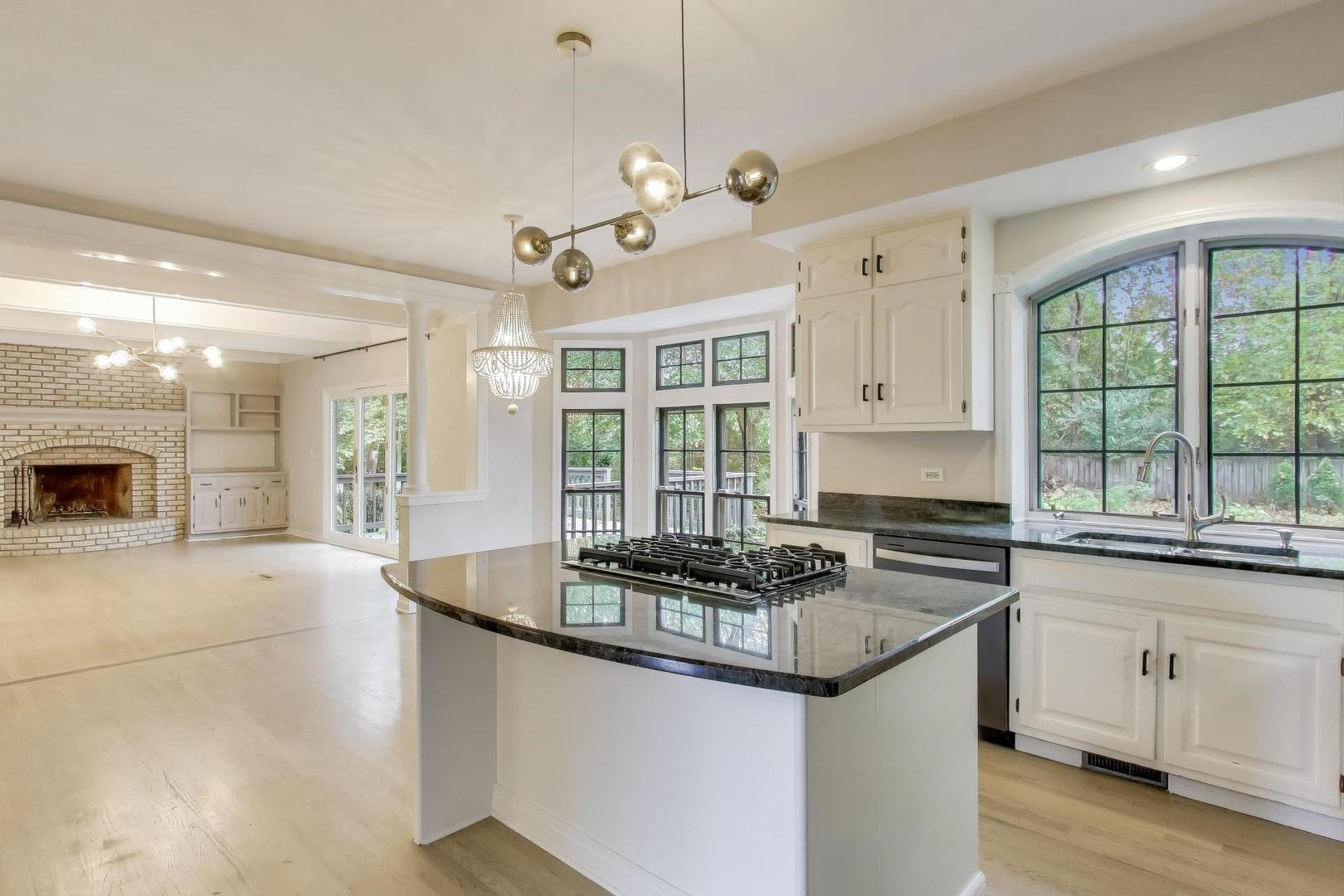 651 Nor-Oaks Court West Chicago, IL 60185 - Photo 21 of 62 a kitchen with granite countertop a sink cabinets and window