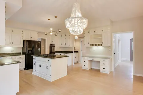 a view of a kitchen with sink cabinets and appliances