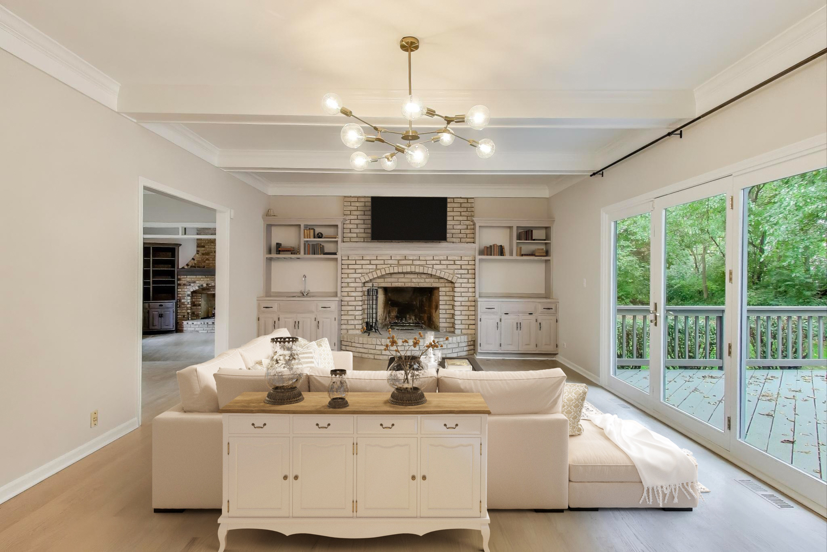 651 Nor-Oaks Court West Chicago, IL 60185 - Photo 23 of 62 a living room with furniture a fireplace and a chandelier