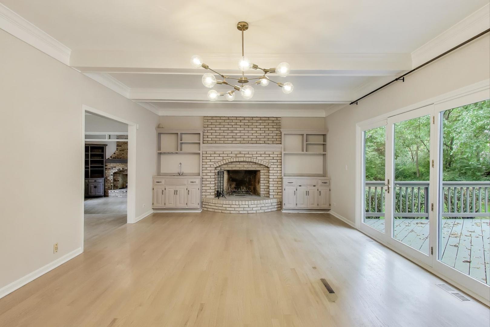 651 Nor-Oaks Court West Chicago, IL 60185 - Photo 24 of 62 a view of an empty room with a fireplace and a window
