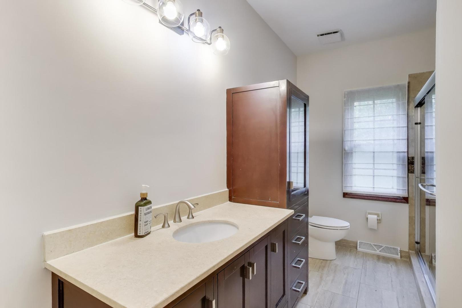 651 Nor-Oaks Court West Chicago, IL 60185 - Photo 32 of 62 a bathroom with a sink toilet and shower