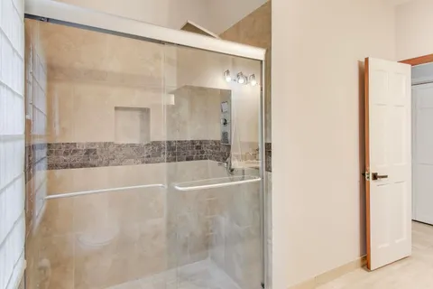 an empty room with windows and closet