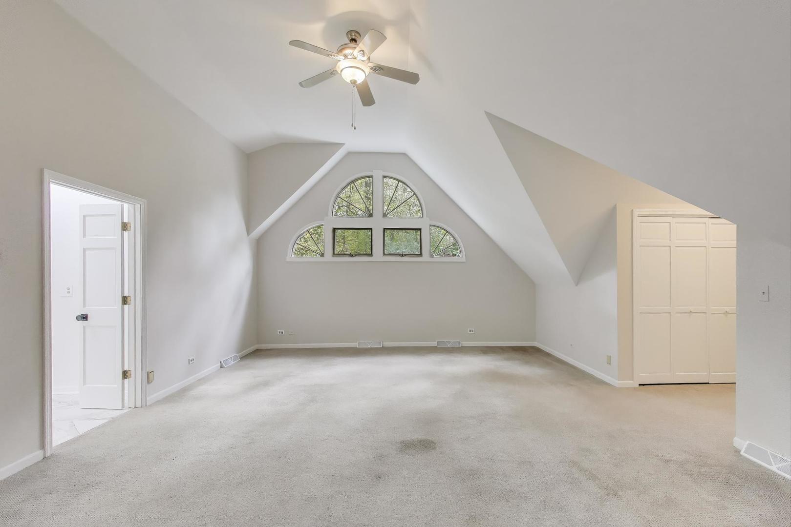 651 Nor-Oaks Court West Chicago, IL 60185 - Photo 37 of 62 an empty room with a window and a ceiling fan