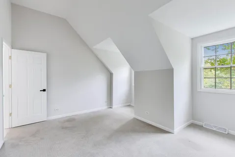 a view of a house with a big yard and large trees