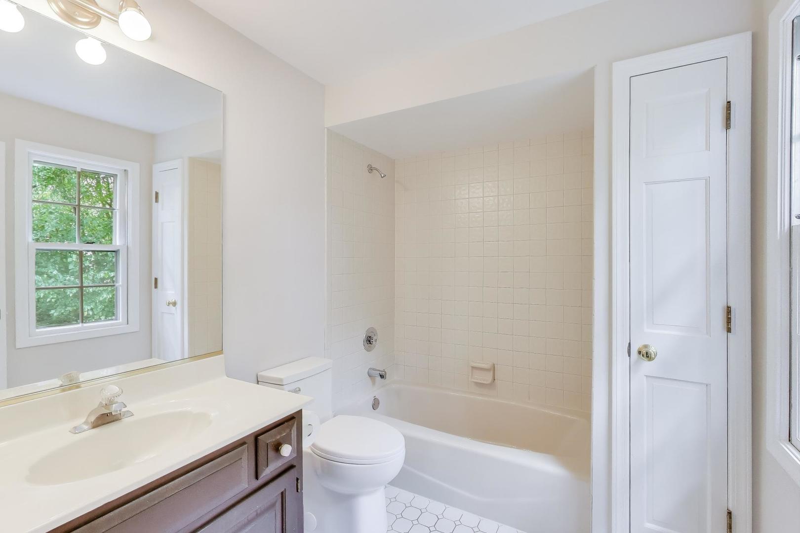 651 Nor-Oaks Court West Chicago, IL 60185 - Photo 50 of 62 a bathroom with a sink toilet bathtub and vanity