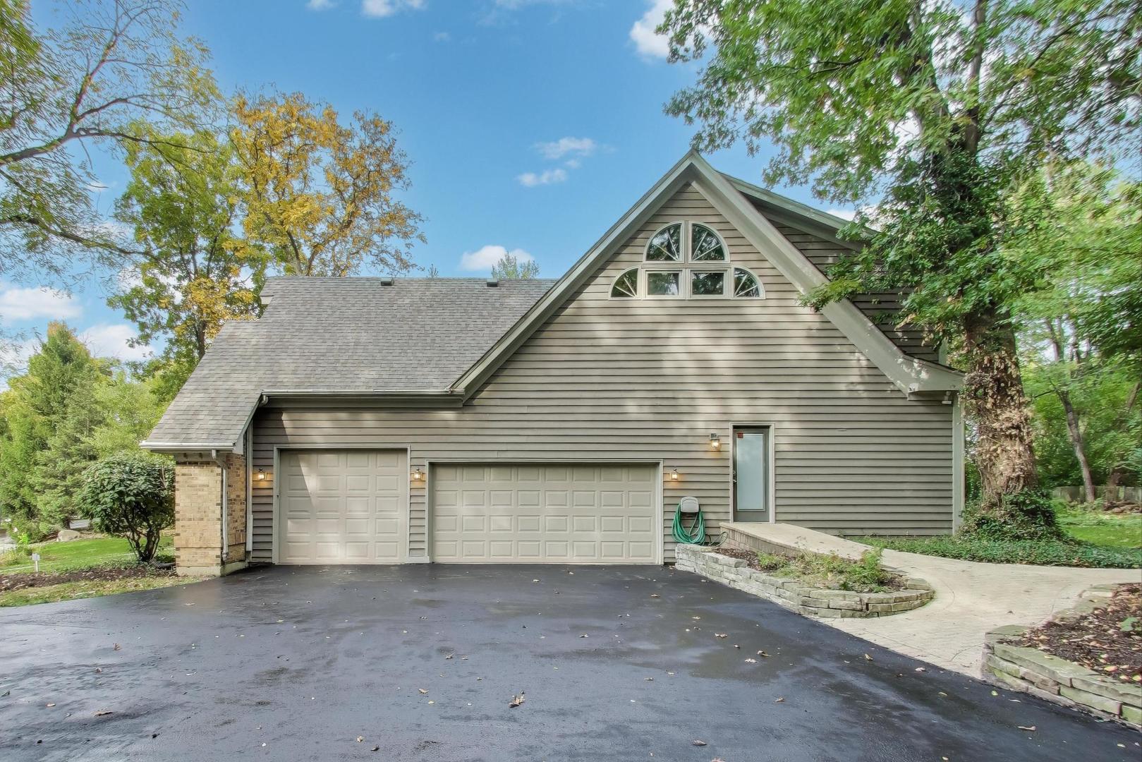 651 Nor-Oaks Court West Chicago, IL 60185 - Photo 5 of 62 a front view of a house with a yard and garage
