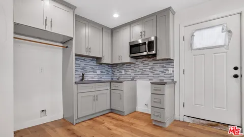 a bathroom with a granite countertop toilet sink and mirror
