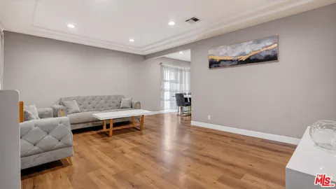 a bedroom with a bed and a night stand