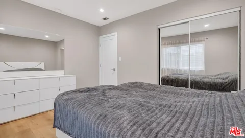 a bedroom with a bed and a chair