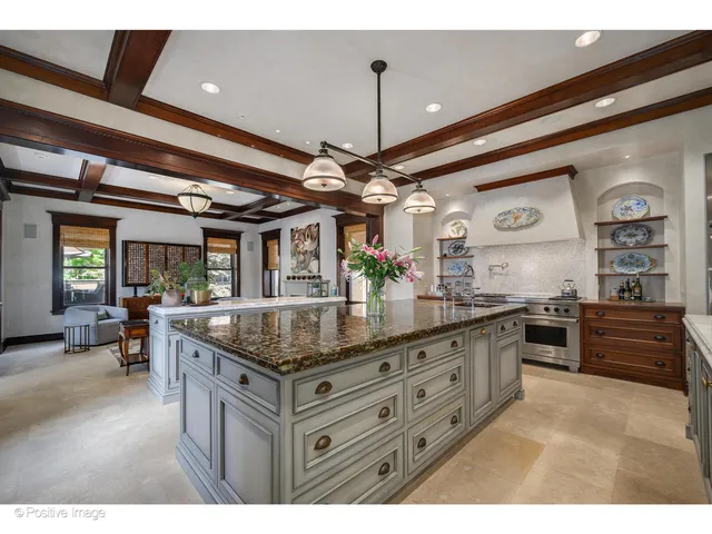 a kitchen with granite countertop a sink stove and cabinets
