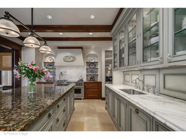 a kitchen with stainless steel appliances granite countertop a sink and stove