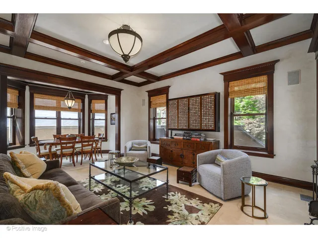a living room with furniture a fireplace and a large window