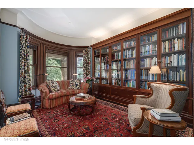 a living room with furniture a chandelier and a window
