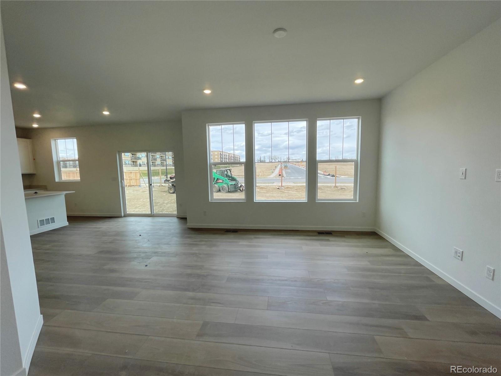4089 Amanda Drive Johnstown, CO 80534 - Photo 2 of 16 an empty room with wooden floor and windows
