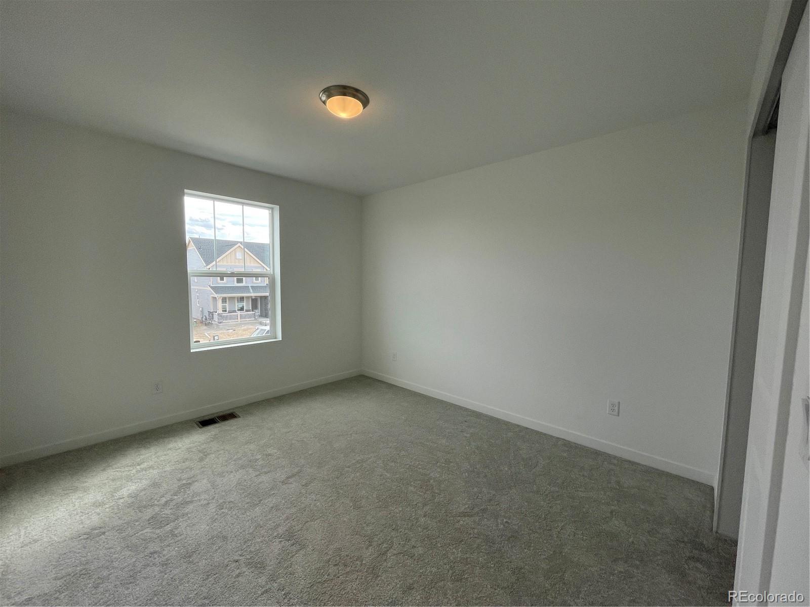 4089 Amanda Drive Johnstown, CO 80534 - Photo 4 of 16 an empty room with windows
