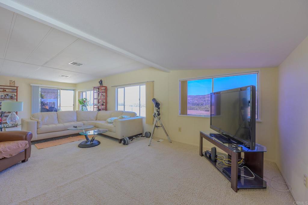 4650 Dulin Road, Unit 27 Fallbrook, CA 92003 - Photo 16 of 37 a living room with furniture and a flat screen tv