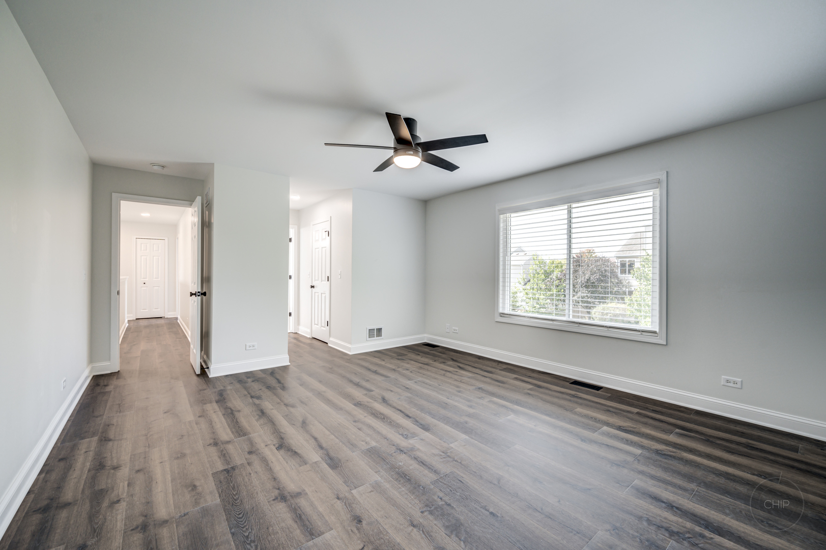 12948 Parterre Place Plainfield, IL 60585 - Photo 24 of 35 an empty room with wooden floor and windows