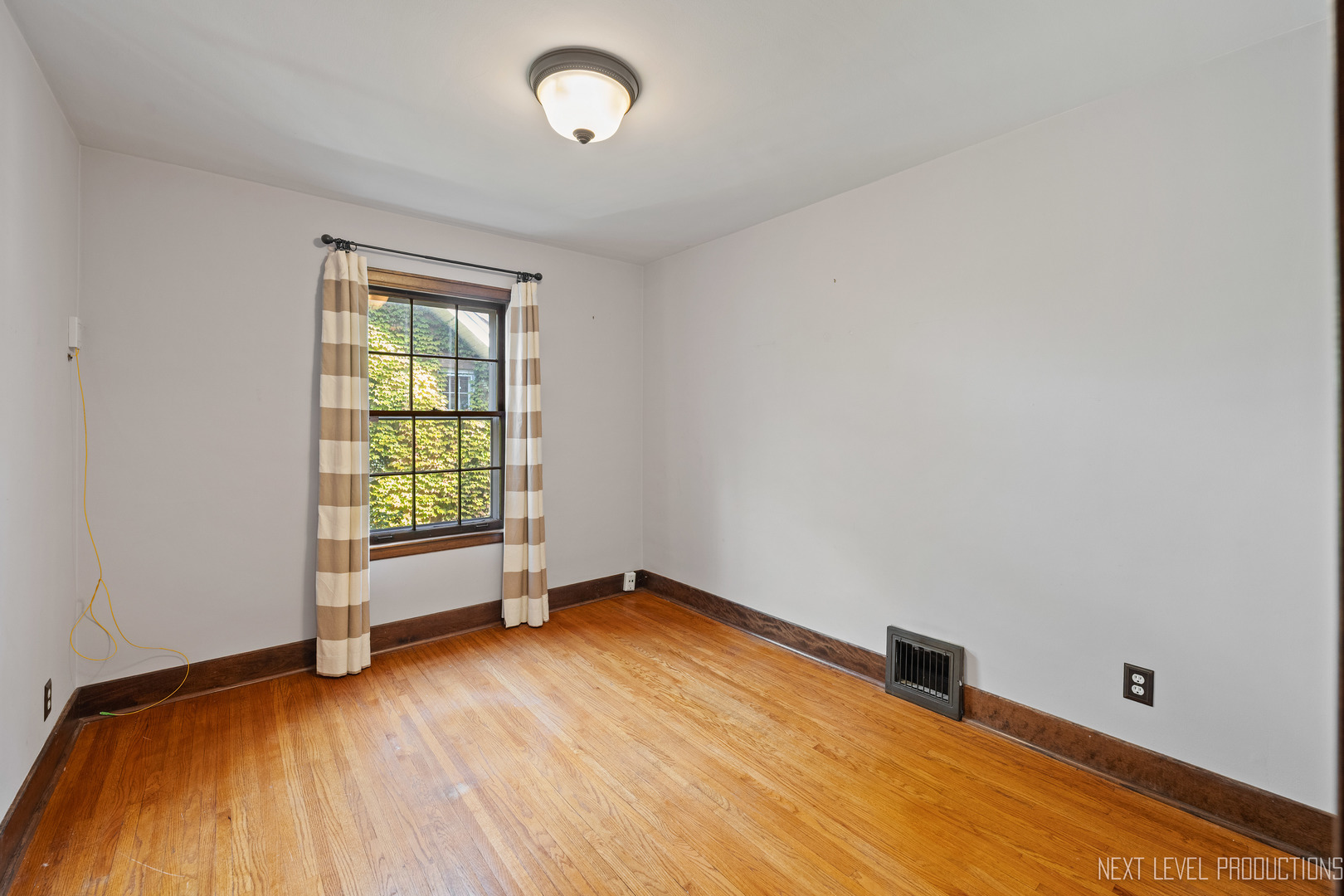 1205 South 4th Street St. Charles, IL 60174 - Photo 16 of 28 an empty room with wooden floor and windows