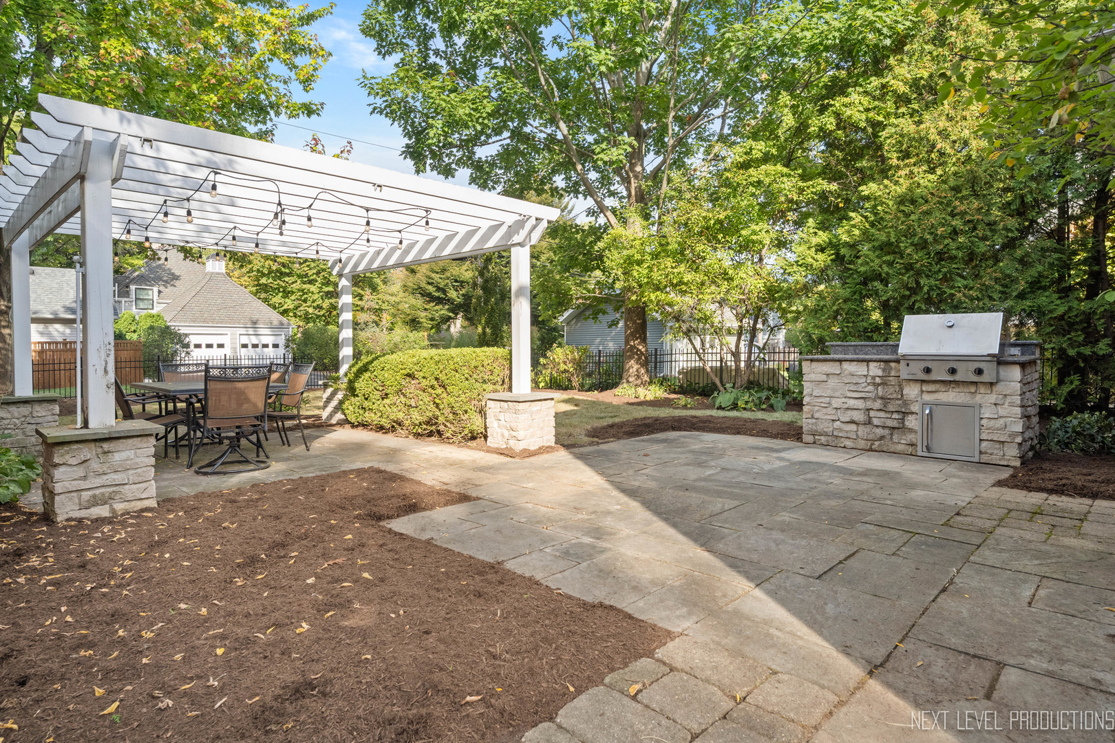 1205 South 4th Street St. Charles, IL 60174 - Photo 24 of 28 a view of a patio with table and chairs under an umbrella