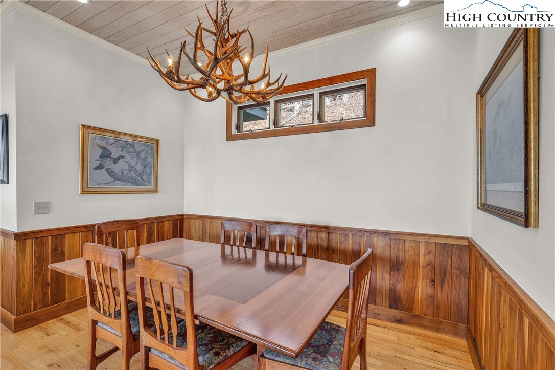933 Thunder Ridge Lane Lenoir, NC 28645 - Photo 16 of 45 a view of a dining room with furniture and a chandelier