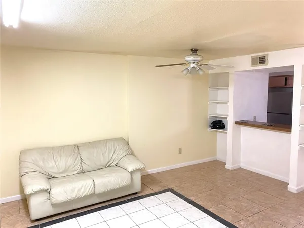 a living room with furniture and a ceiling fan
