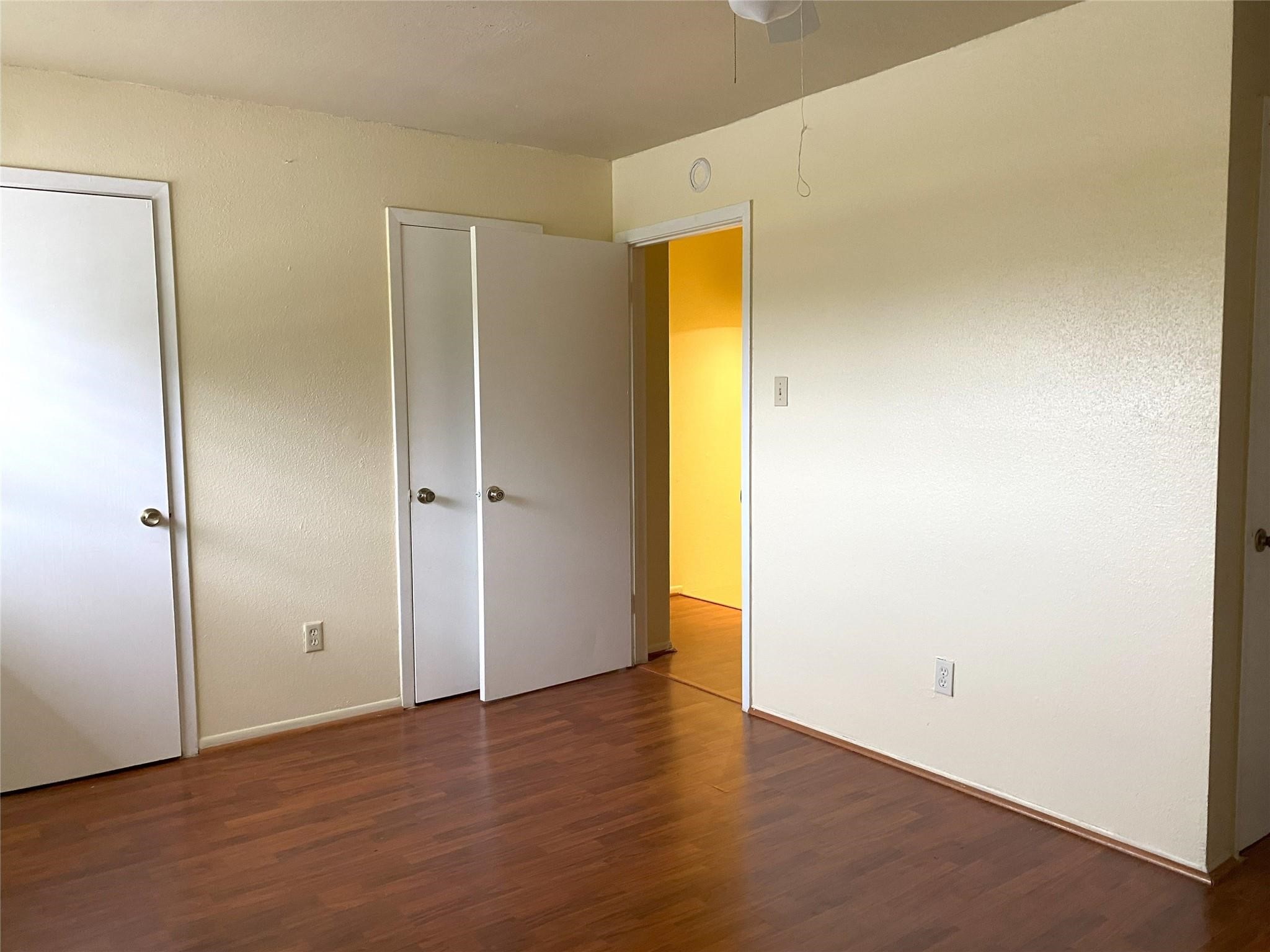 7831 Fuqua Street, Unit 7831 Houston, TX 77075 - Photo 2 of 15 an empty room with wooden floor and a window