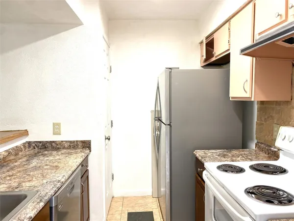 a kitchen with a stove and a refrigerator