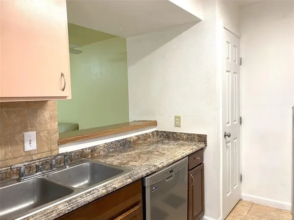 a kitchen with granite countertop a sink and a stove