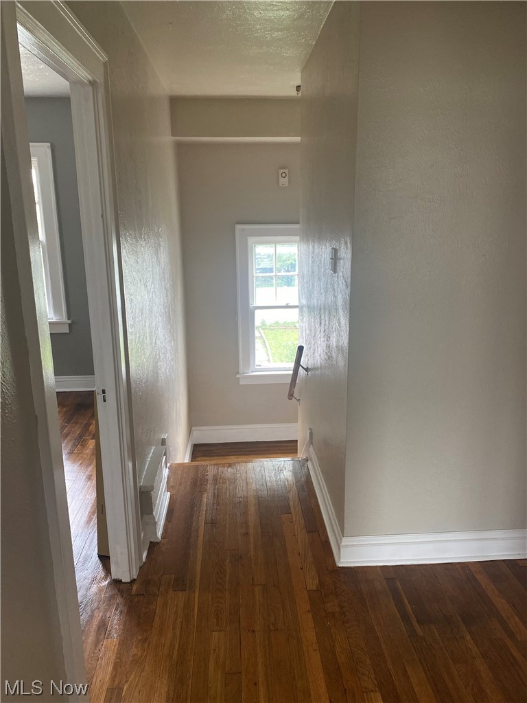 4688 Rockwood Road Cleveland, OH 44125 - Photo 35 of 35 Hall featuring dark hardwood floors and a textured ceiling