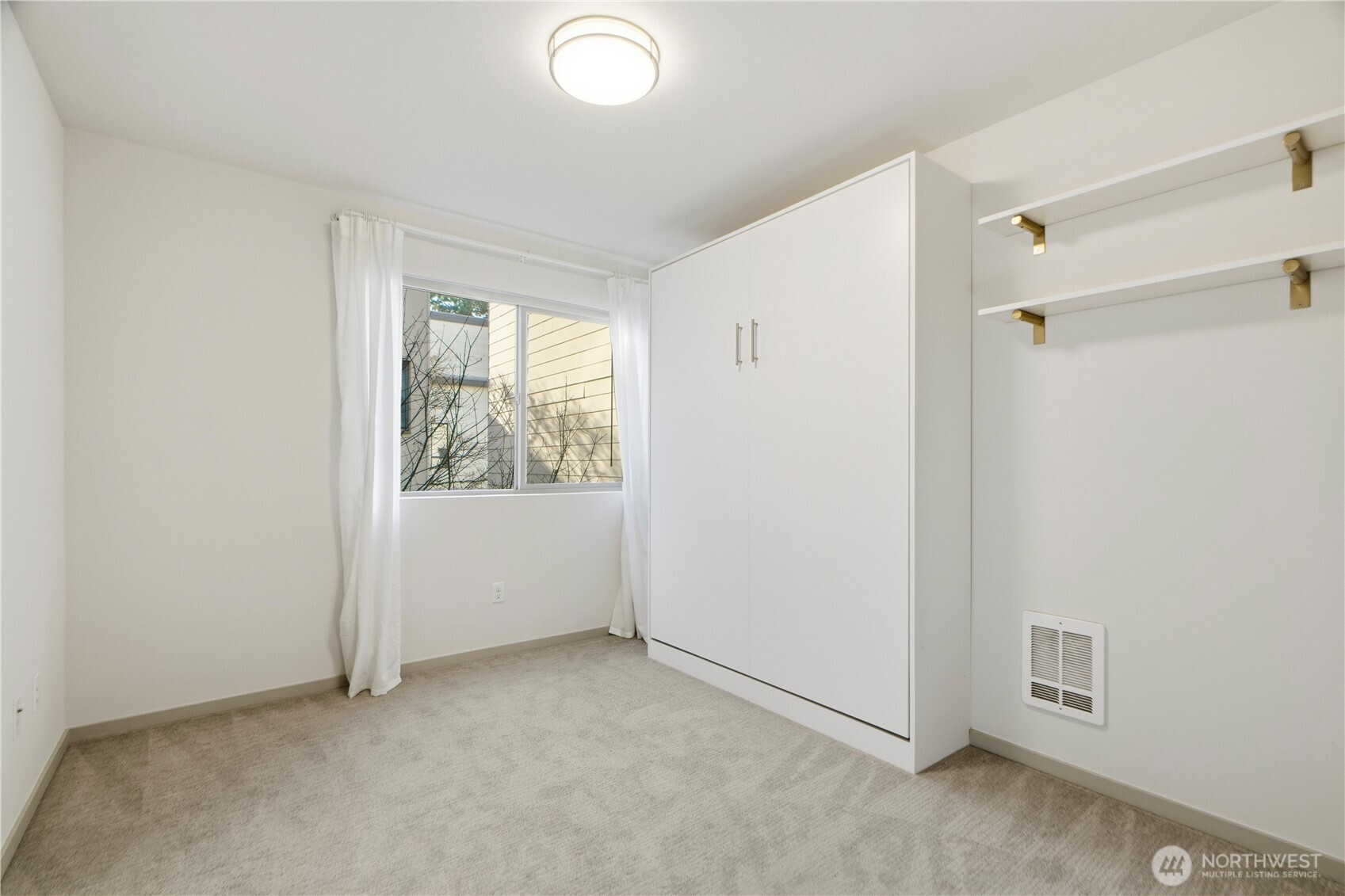 4416 Francis Avenue North, Unit B Seattle, WA 98103 - Photo 14 of 26 a view of an empty room with a window