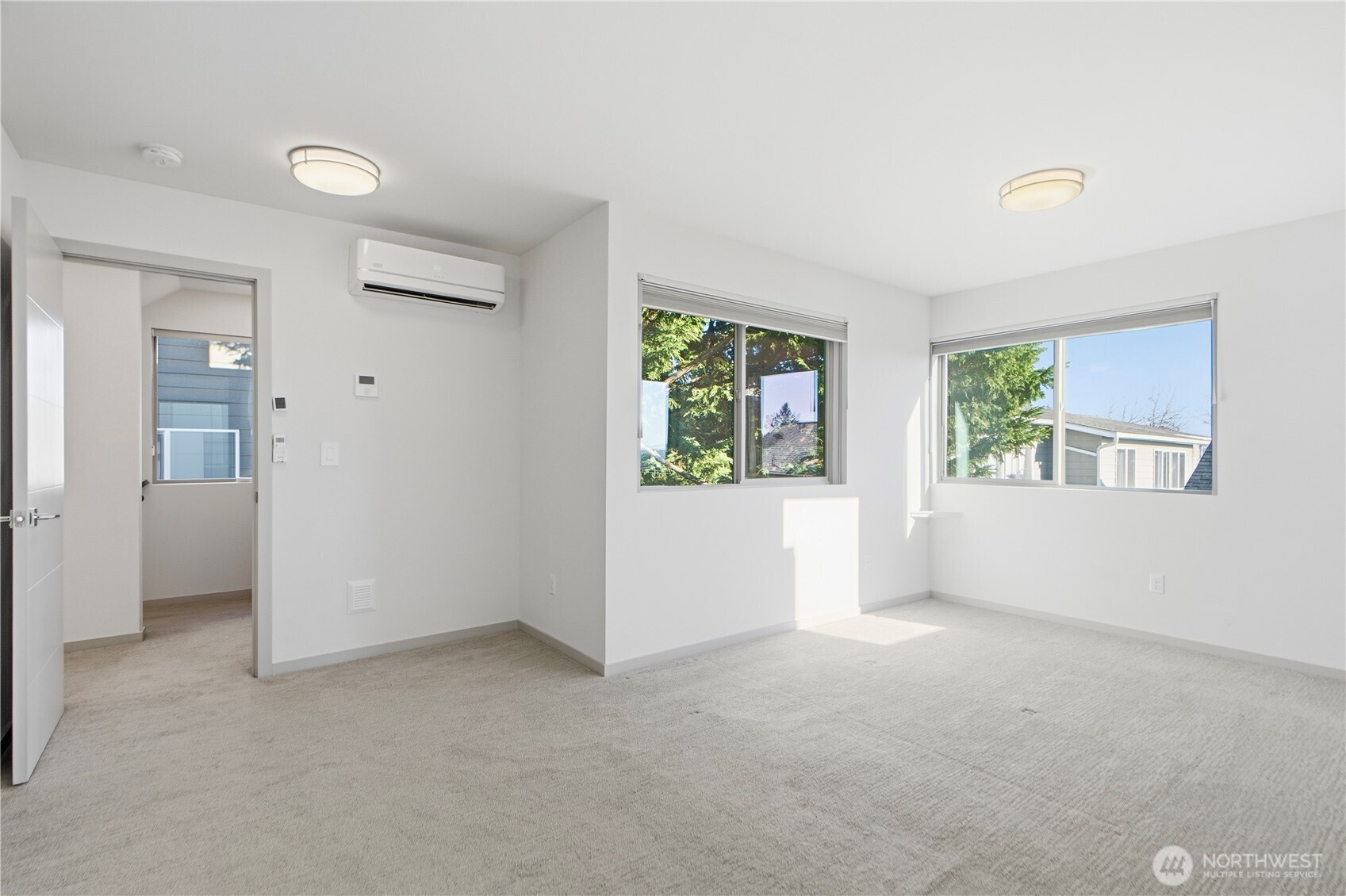 4416 Francis Avenue North, Unit B Seattle, WA 98103 - Photo 18 of 26 an empty room with windows and closet