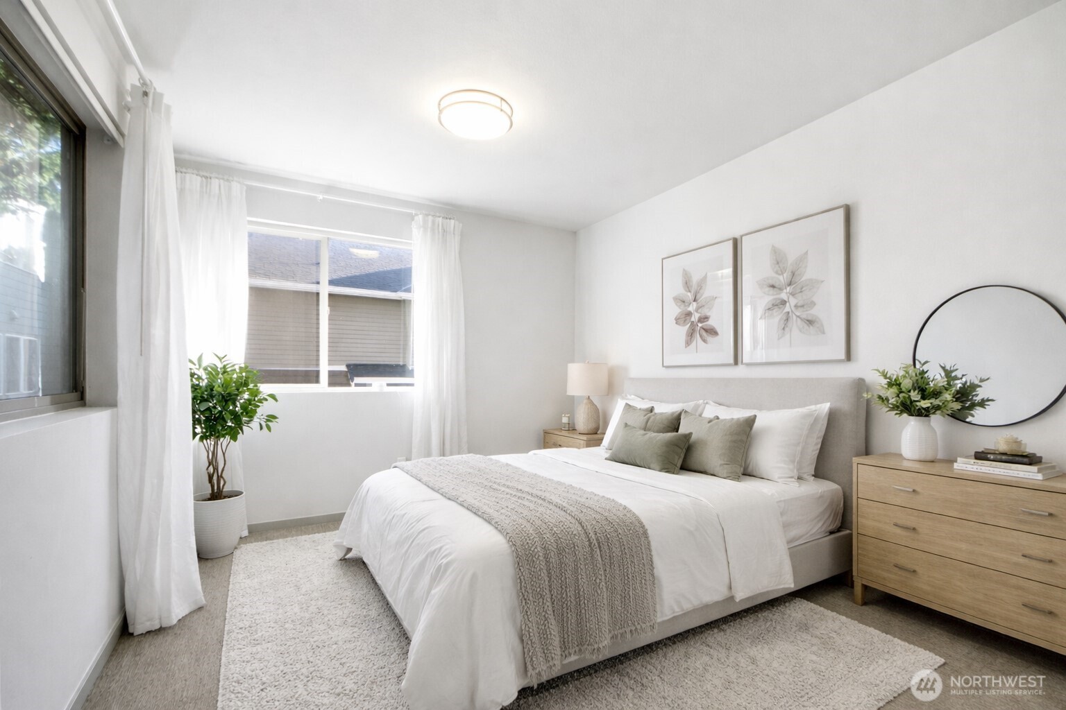 4416 Francis Avenue North, Unit B Seattle, WA 98103 - Photo 9 of 26 a bedroom with a bed and a potted plant