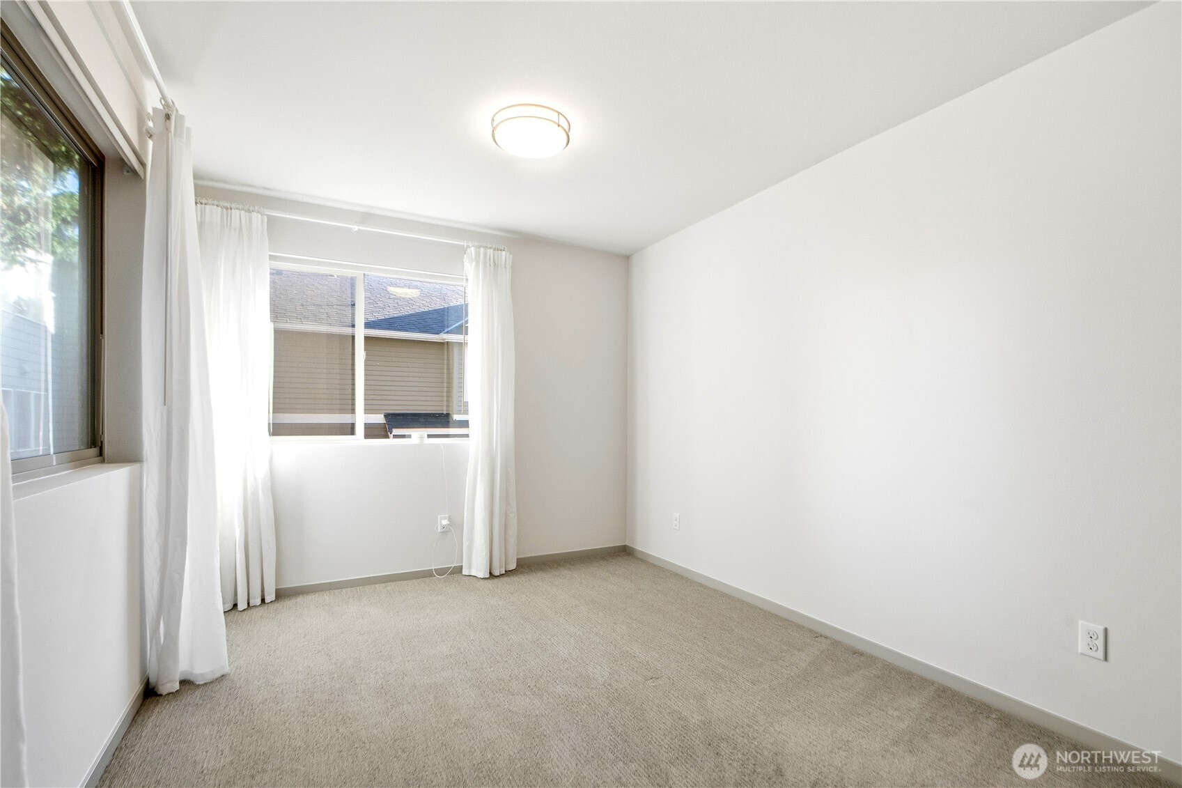 4416 Francis Avenue North, Unit B Seattle, WA 98103 - Photo 10 of 26 an empty room with windows