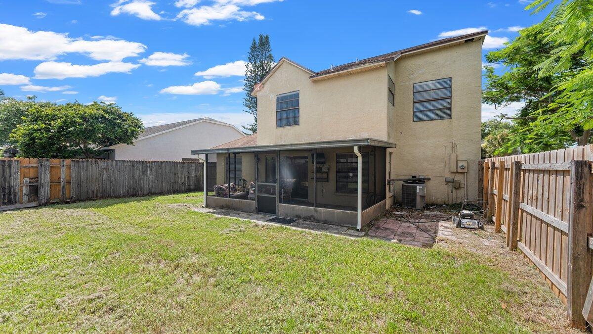 1645 Clover Circle Melbourne, FL 32935 - Photo 11 of 43 a view of a backyard with table and chairs and wooden fence