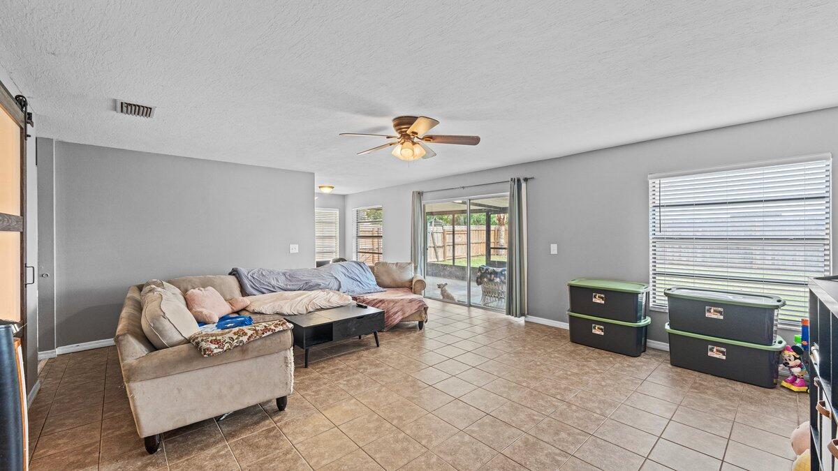 1645 Clover Circle Melbourne, FL 32935 - Photo 16 of 43 a living room with furniture and a window