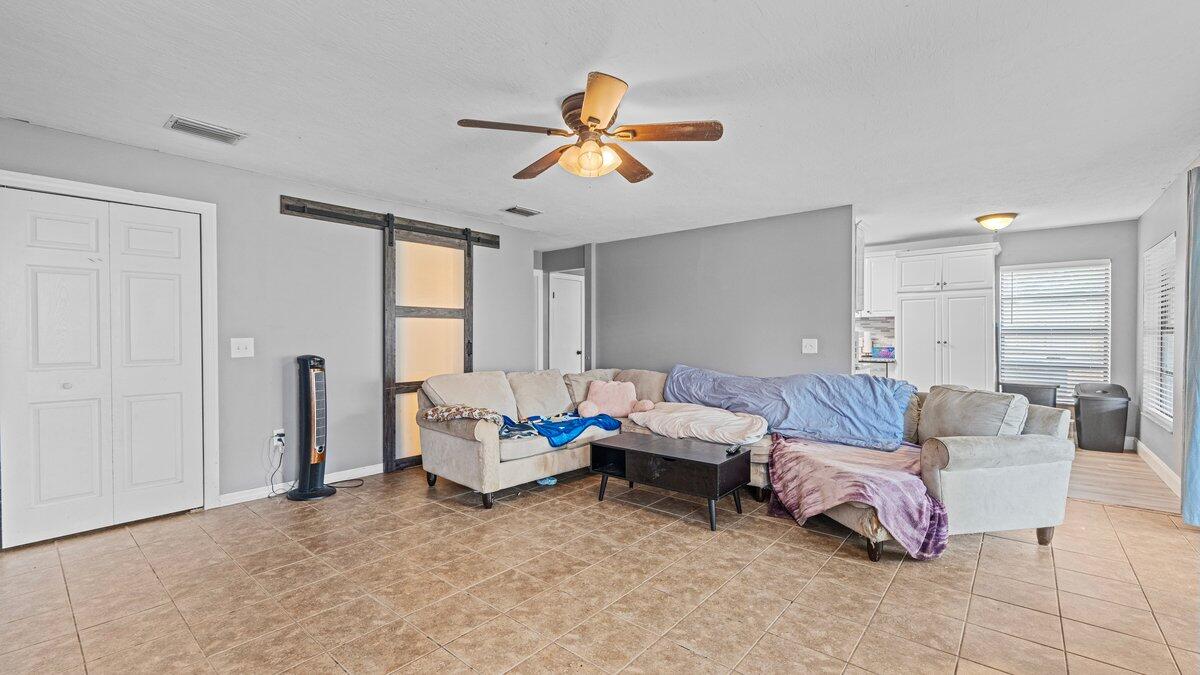 1645 Clover Circle Melbourne, FL 32935 - Photo 17 of 43 a living room with furniture chess table and a window