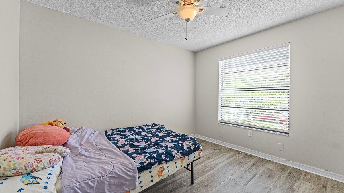 1645 Clover Circle Melbourne, FL 32935 - Photo 20 of 43 a bedroom with a bed and a window