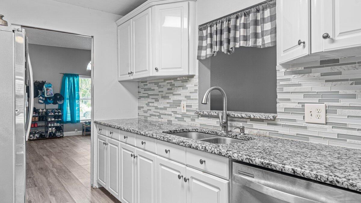 1645 Clover Circle Melbourne, FL 32935 - Photo 2 of 43 a kitchen with granite countertop a sink and cabinets