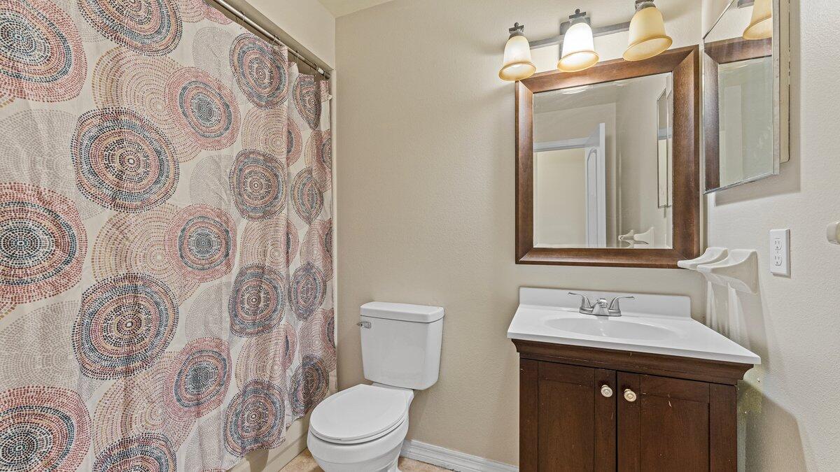 1645 Clover Circle Melbourne, FL 32935 - Photo 29 of 43 a bathroom with a sink and mirror with toilet