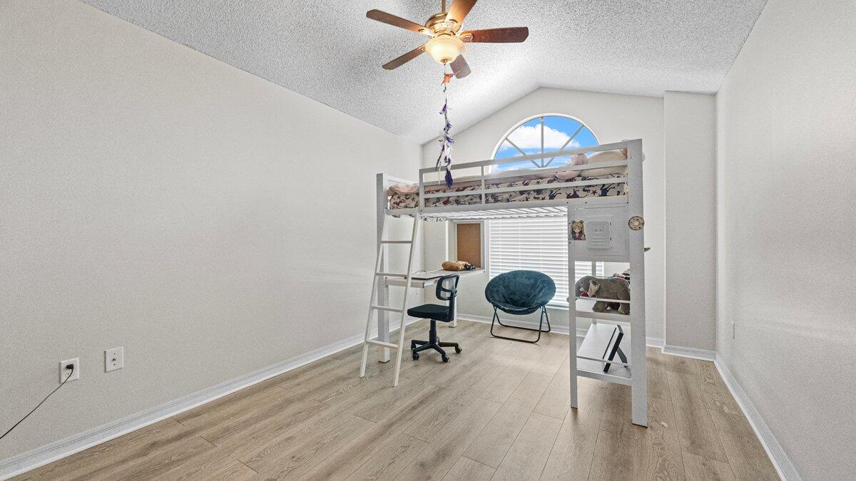 1645 Clover Circle Melbourne, FL 32935 - Photo 30 of 43 a view of a livingroom with wooden floor and a ceiling fan