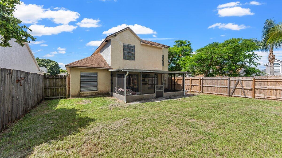 1645 Clover Circle Melbourne, FL 32935 - Photo 31 of 43 a view of a house with backyard and trees