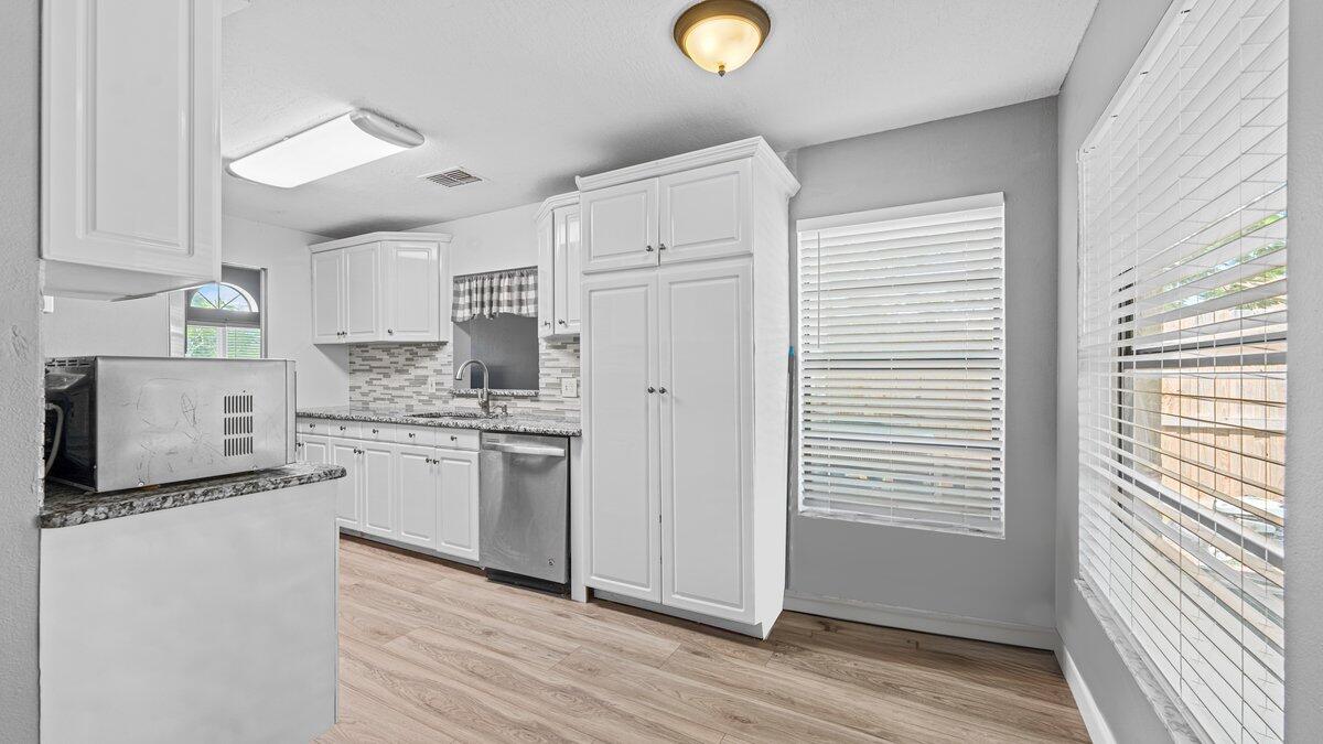 1645 Clover Circle Melbourne, FL 32935 - Photo 4 of 43 a kitchen with stainless steel appliances granite countertop a stove a sink and a refrigerator