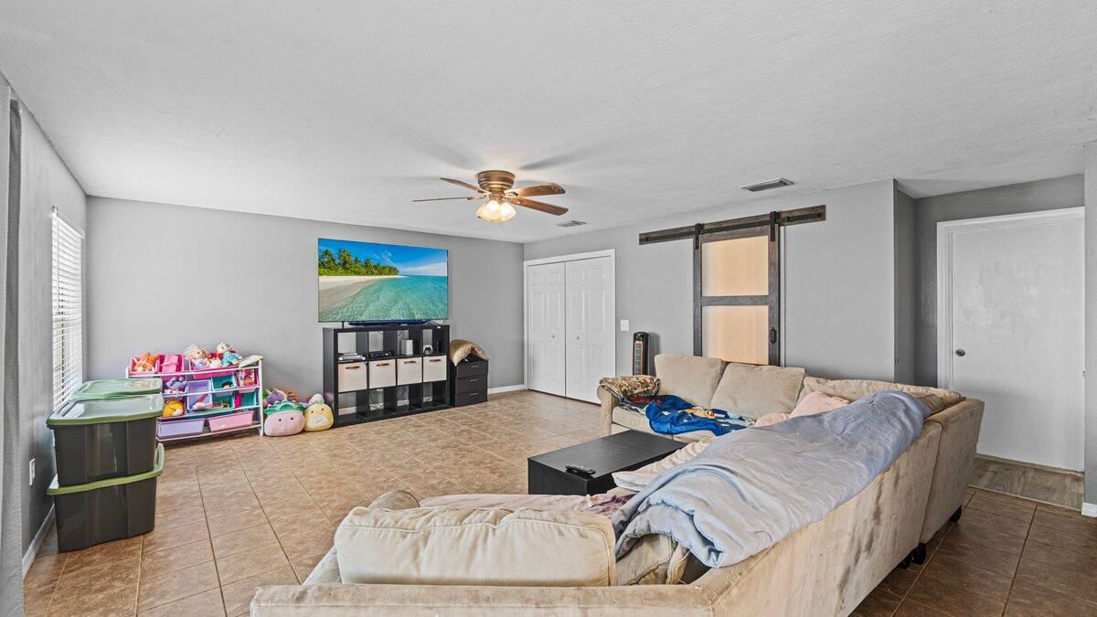 1645 Clover Circle Melbourne, FL 32935 - Photo 5 of 43 a bedroom with bed and a window