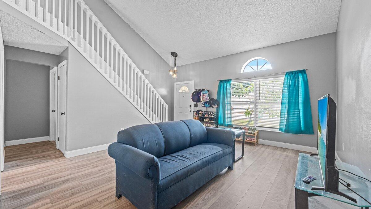 1645 Clover Circle Melbourne, FL 32935 - Photo 9 of 43 a living room with furniture and a large window