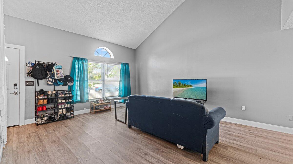 1645 Clover Circle Melbourne, FL 32935 - Photo 10 of 43 a living room with furniture and a flat screen tv